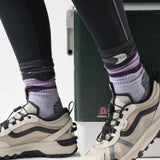 Chaussette de randonnée Smartwool Lunar Trek pour femme en laine mérinos, coloris éclipse violette avec motif huard et lune, portée avec des espadrilles